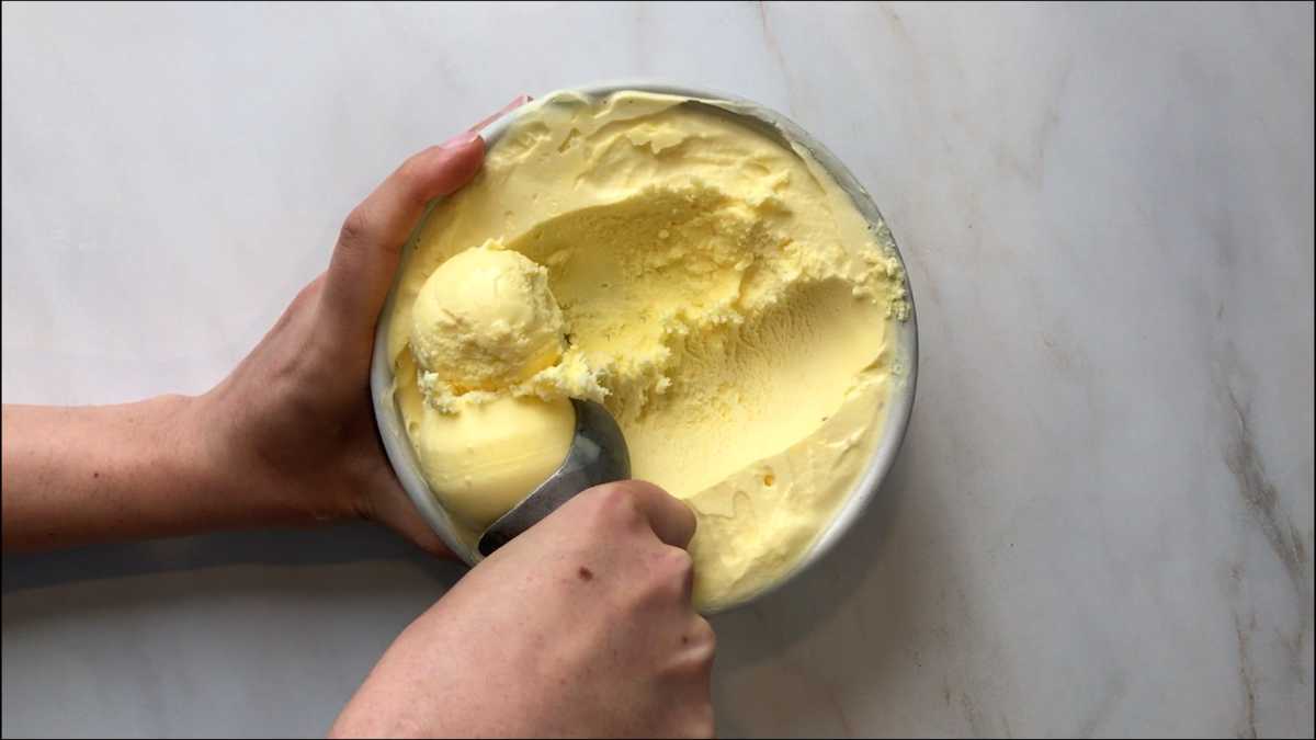 Scooping yellow ice cream.