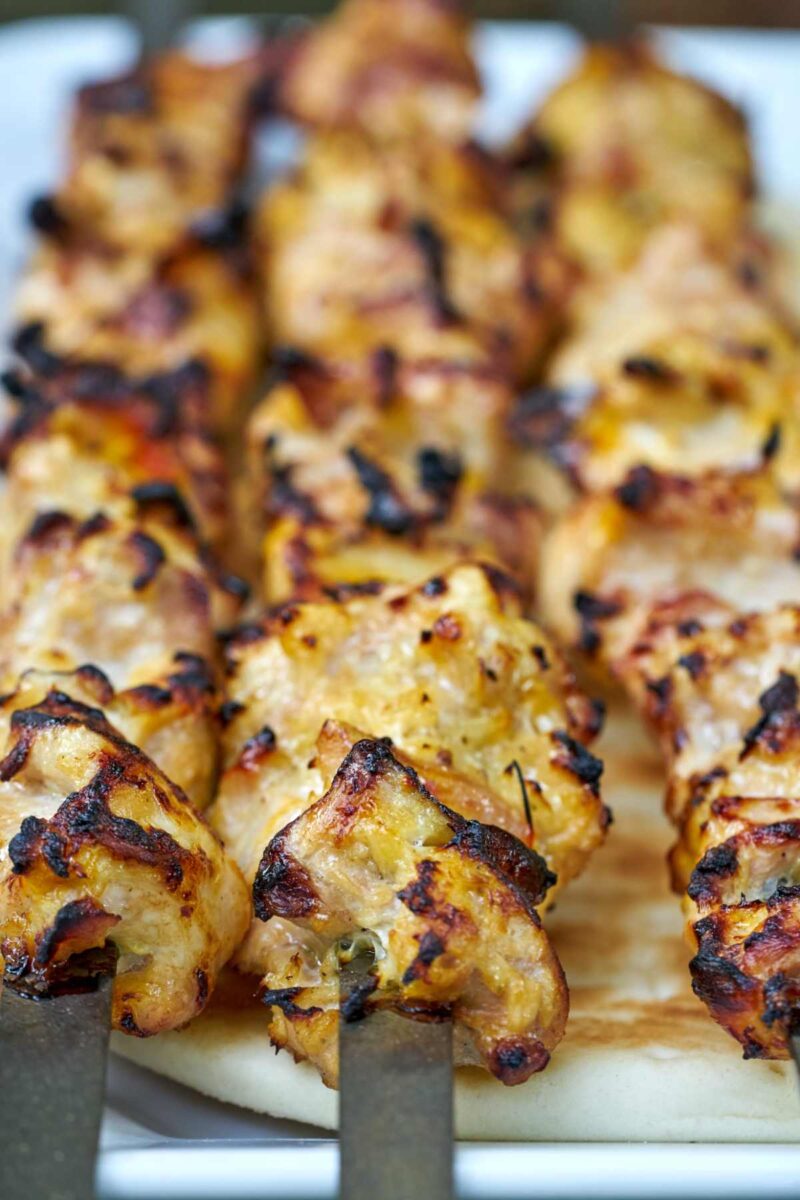 Chicken kabobs on metal skewers.