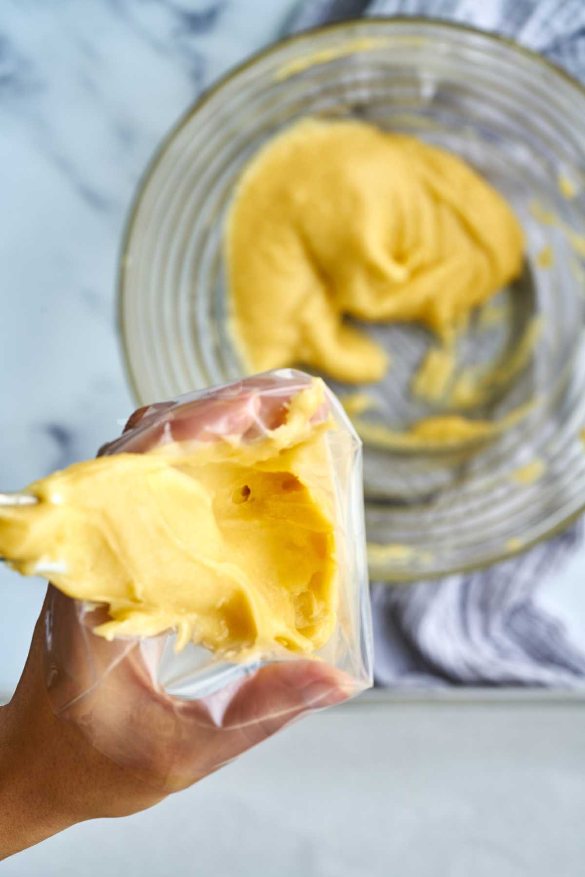 Yellow dough in a piping bag.