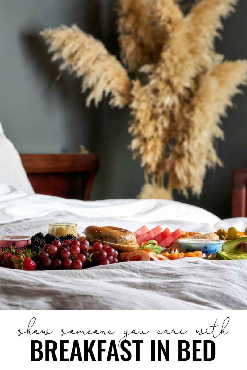 Breakfast board in a bed with pampas grass.