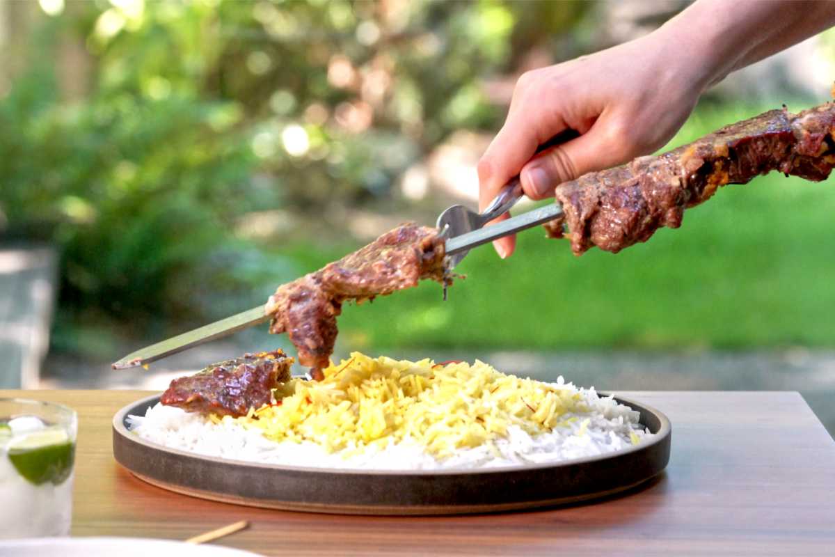 Taking kabob off a skewer.