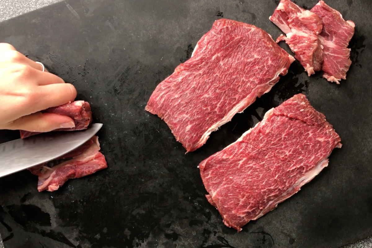 Raw meat on a cutting board.