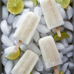 White popsicles over ice with limes.