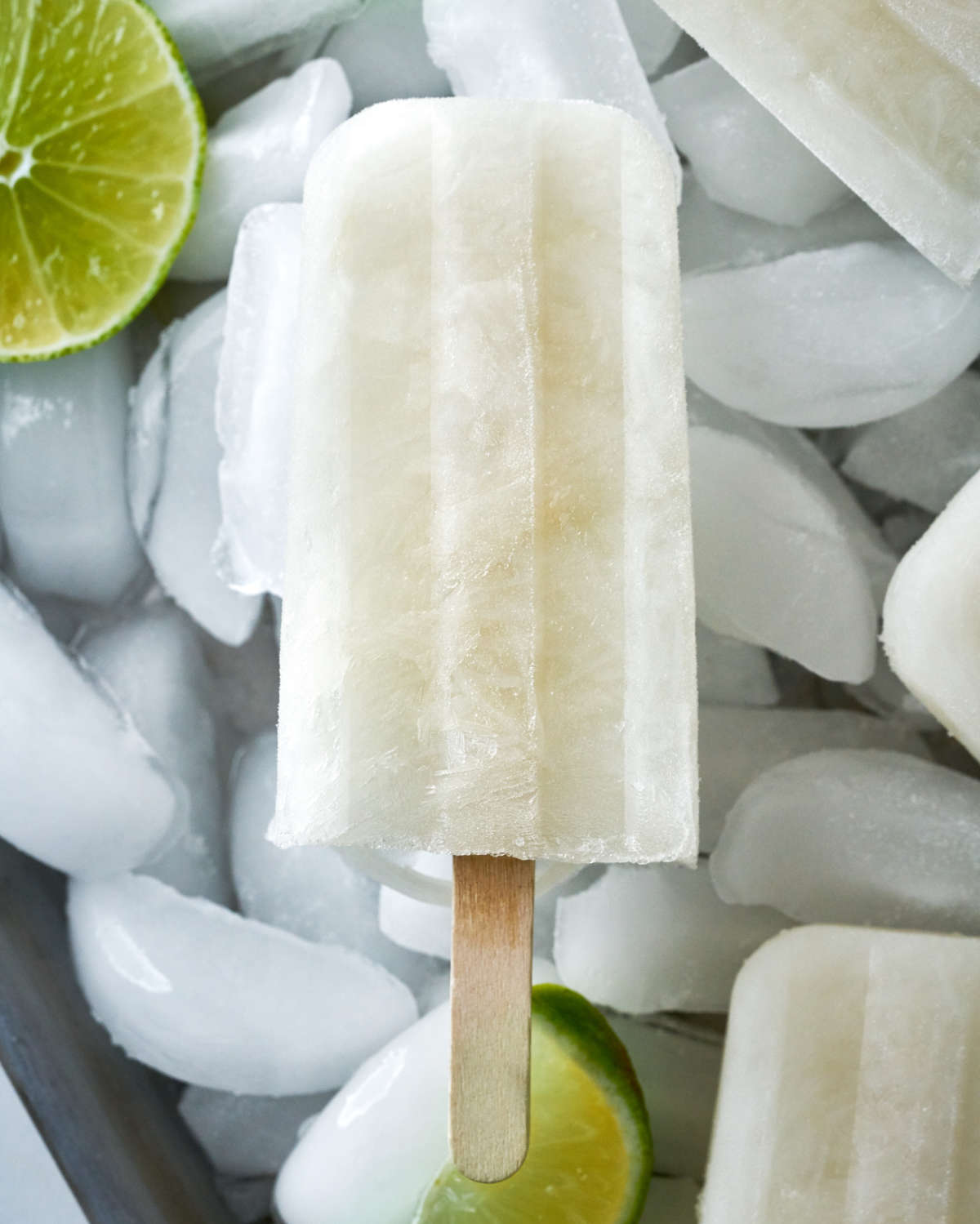 White popsicles over ice with limes.