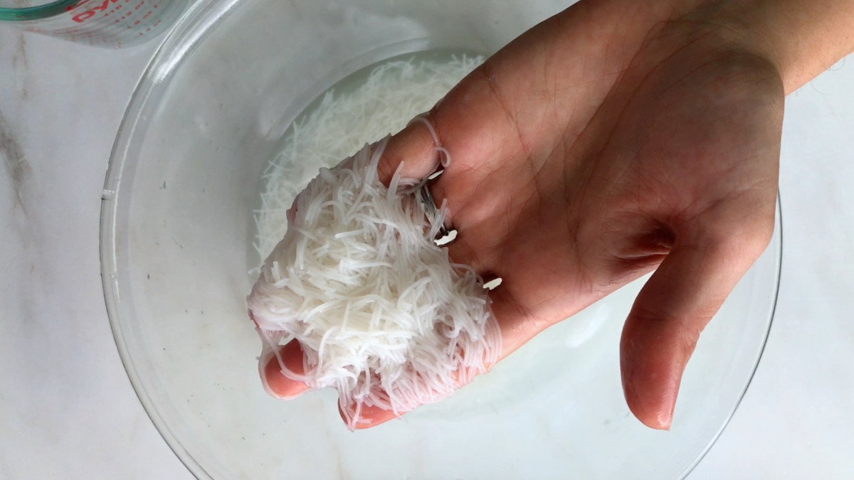 Rice noodles in a hand.