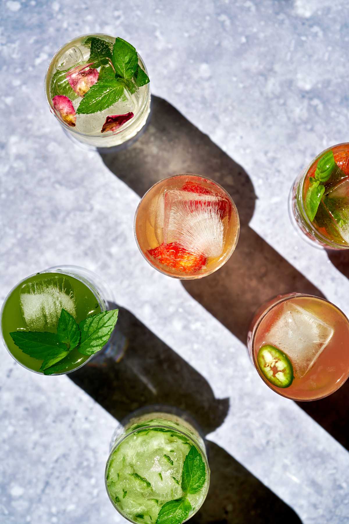 Glasses with different colored drinks.