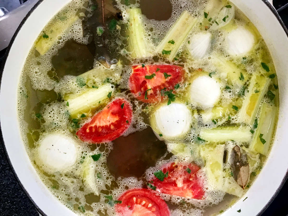 Pot of vegetable soup with large chunks of vegetables.