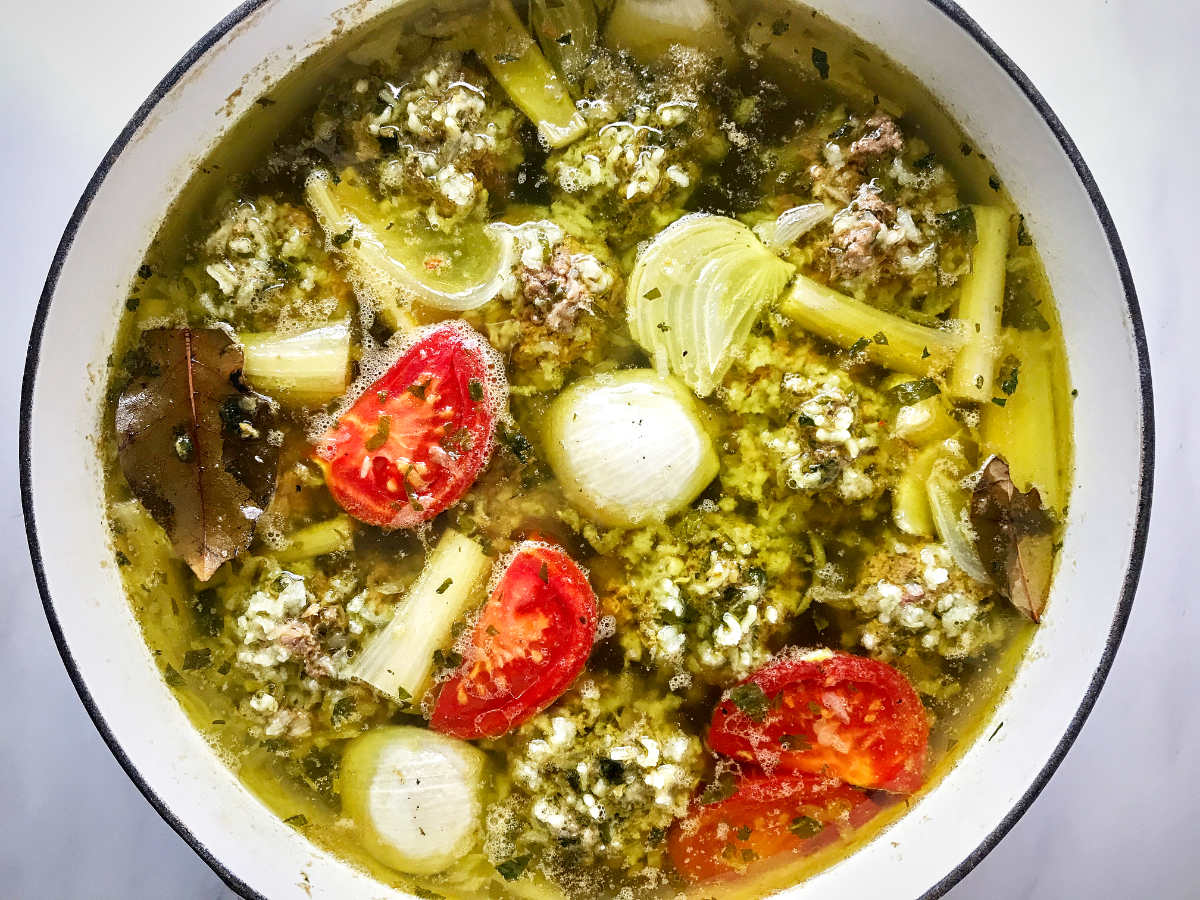 Pot of soup with rice dumplings.