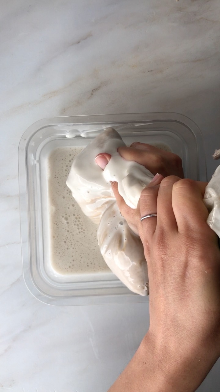 Squeezing liquid through a bag.