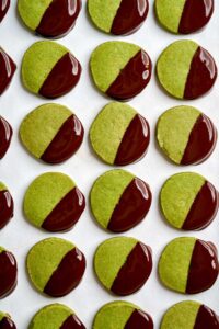 Green cookies dipped in chocolate.