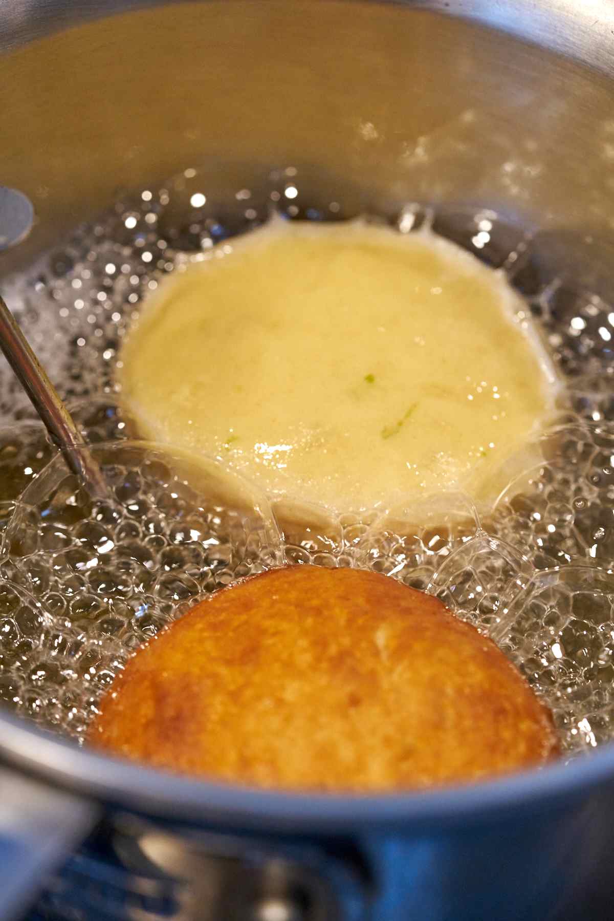 Frying doughnuts in oil.