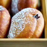 Filled doughnuts in a box.