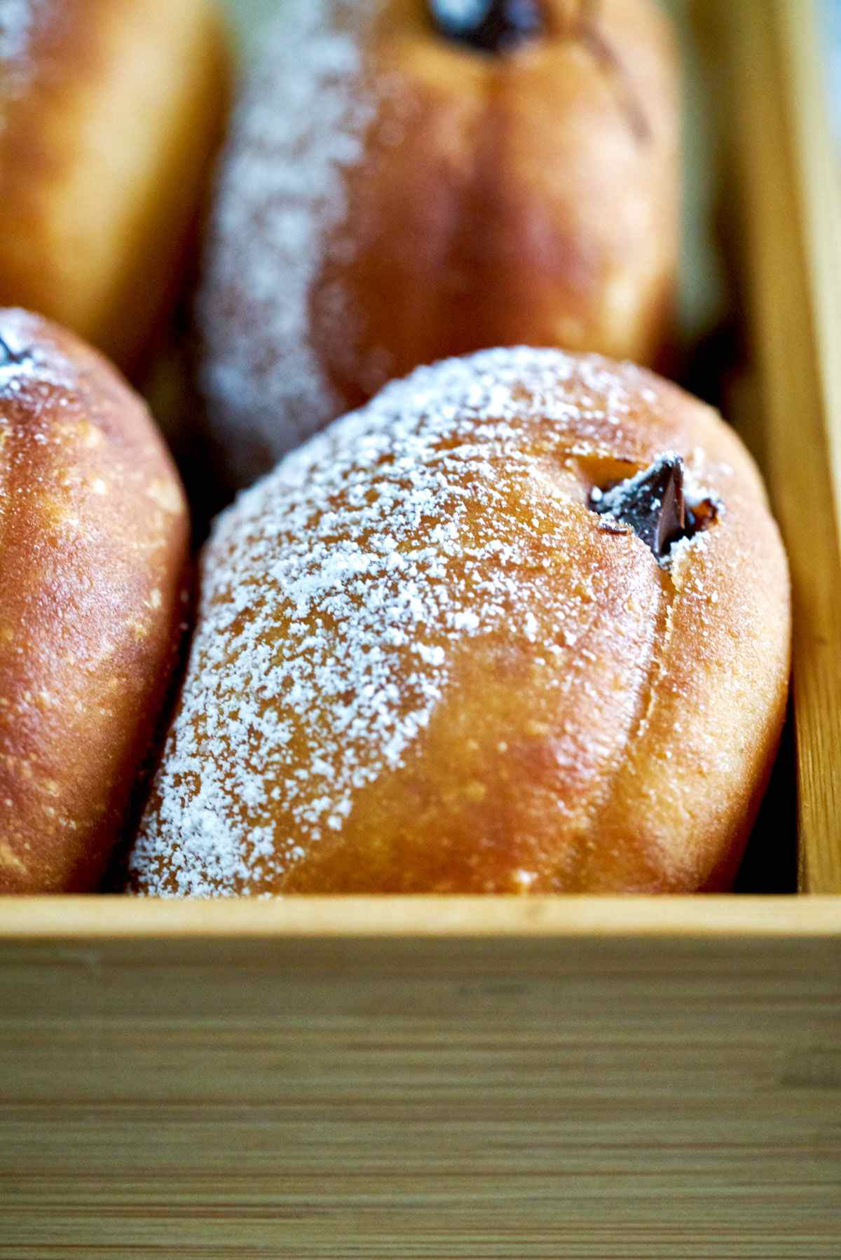 Filled doughnuts in a box.