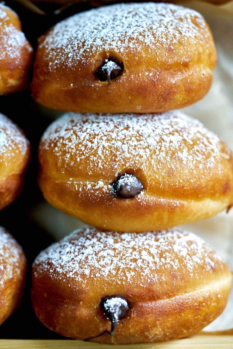 Stack of chocolate filled doughnuts.