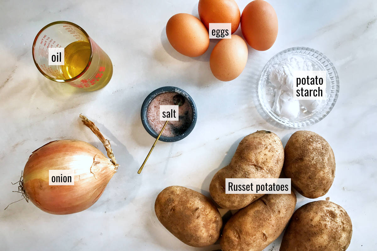 Potatoes and other ingredients on a countertop.