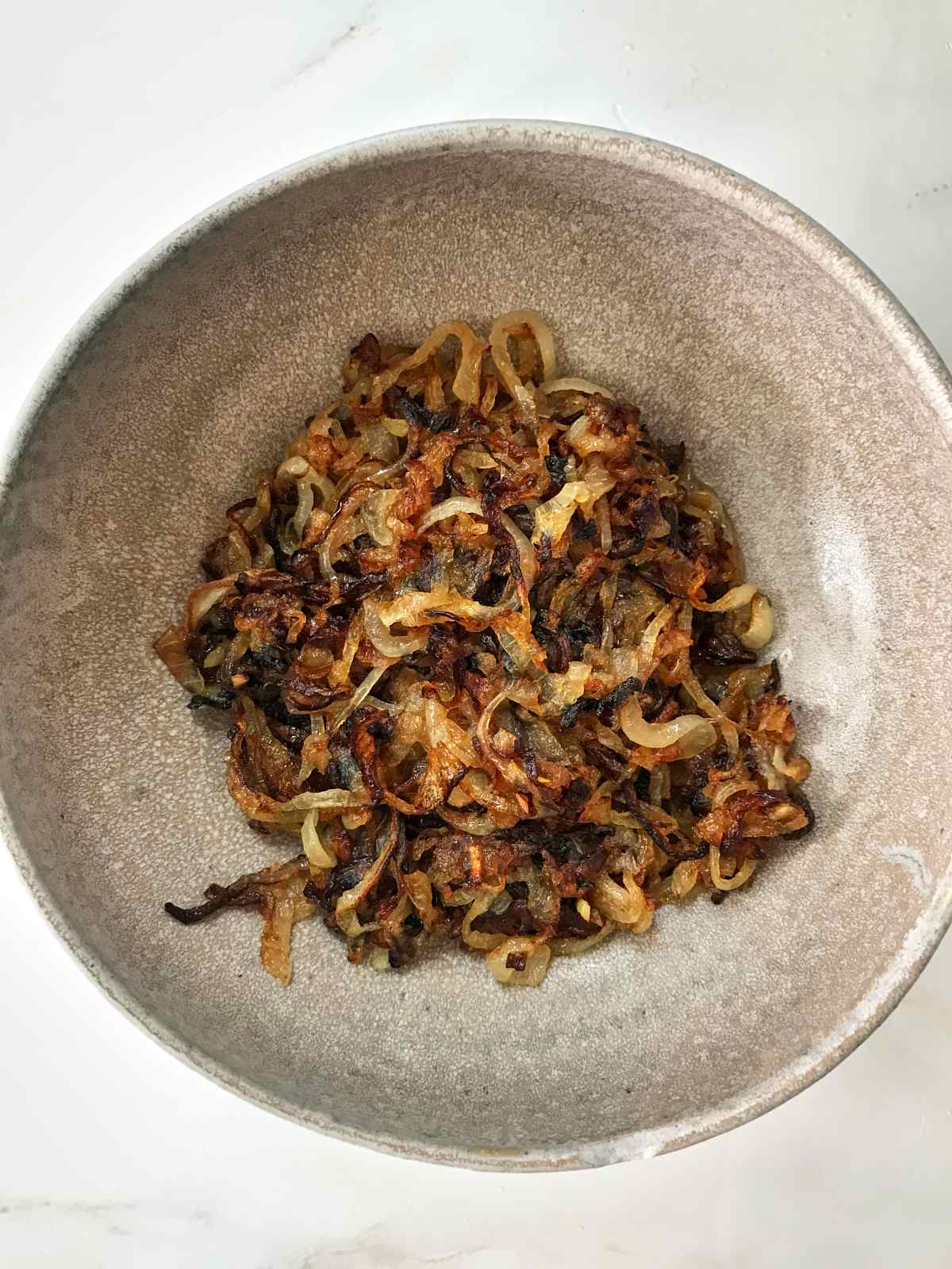 Browned onions in a bowl.