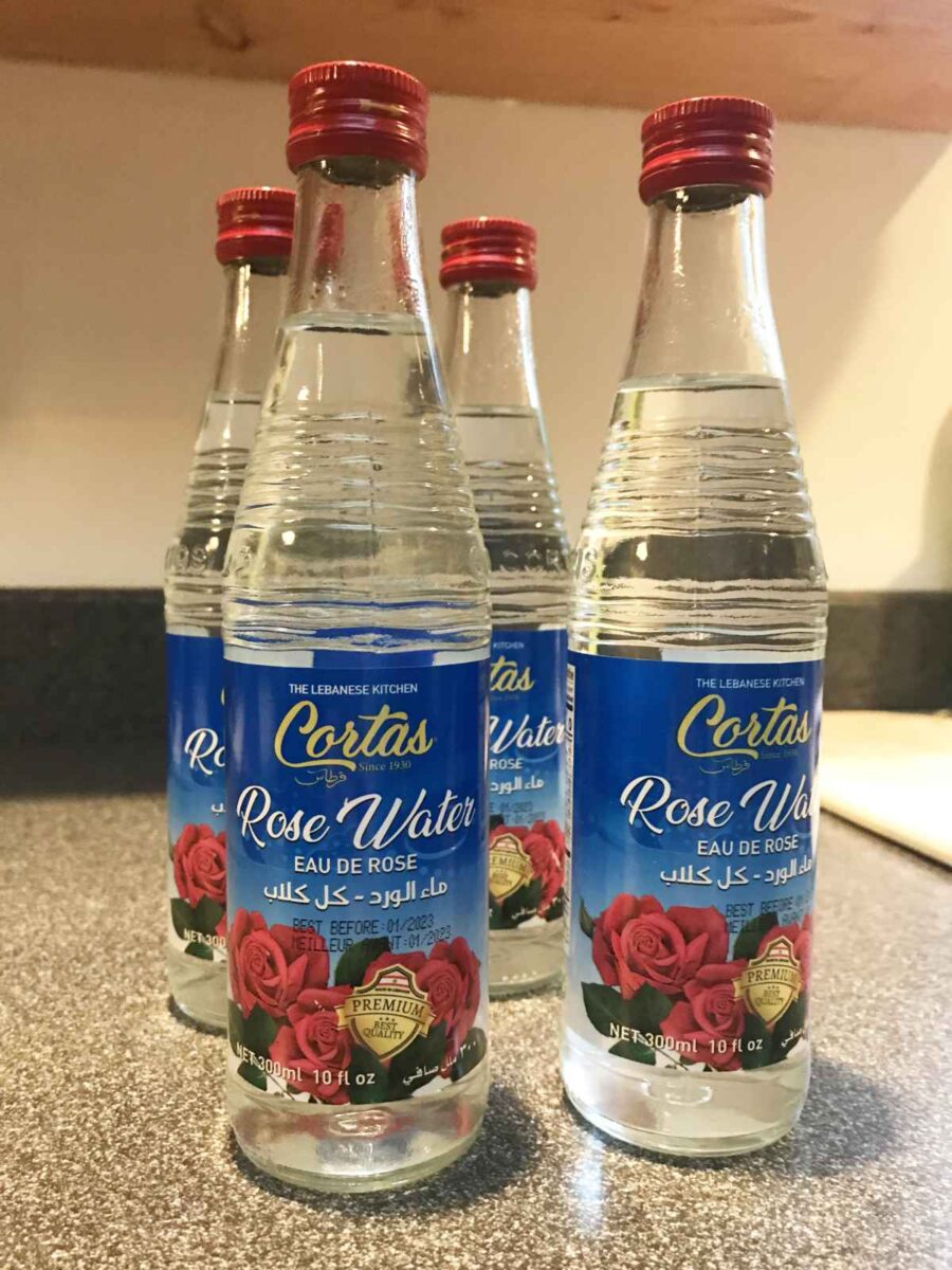 Bottles of rose water on a countertop.