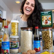 Woman in kitchen with packaged pantry foods.