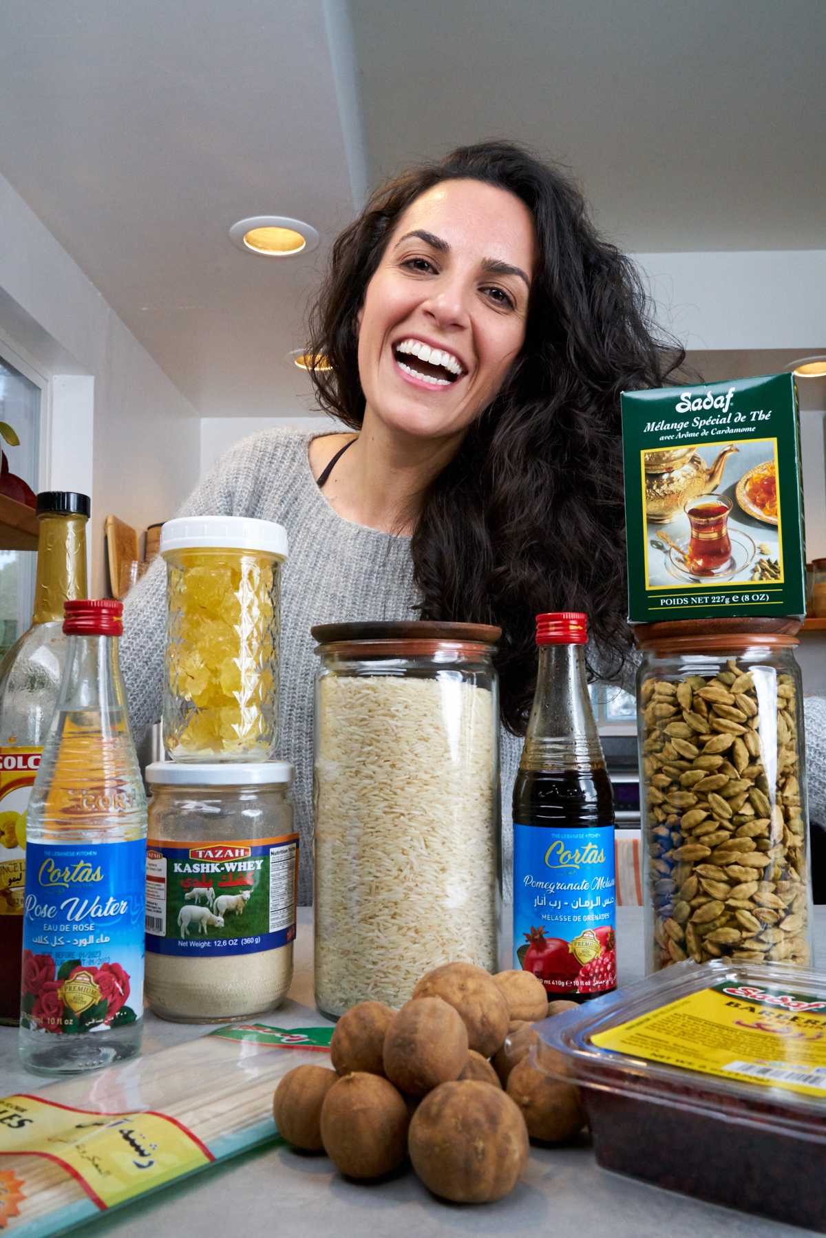 Woman in kitchen with packaged pantry foods.