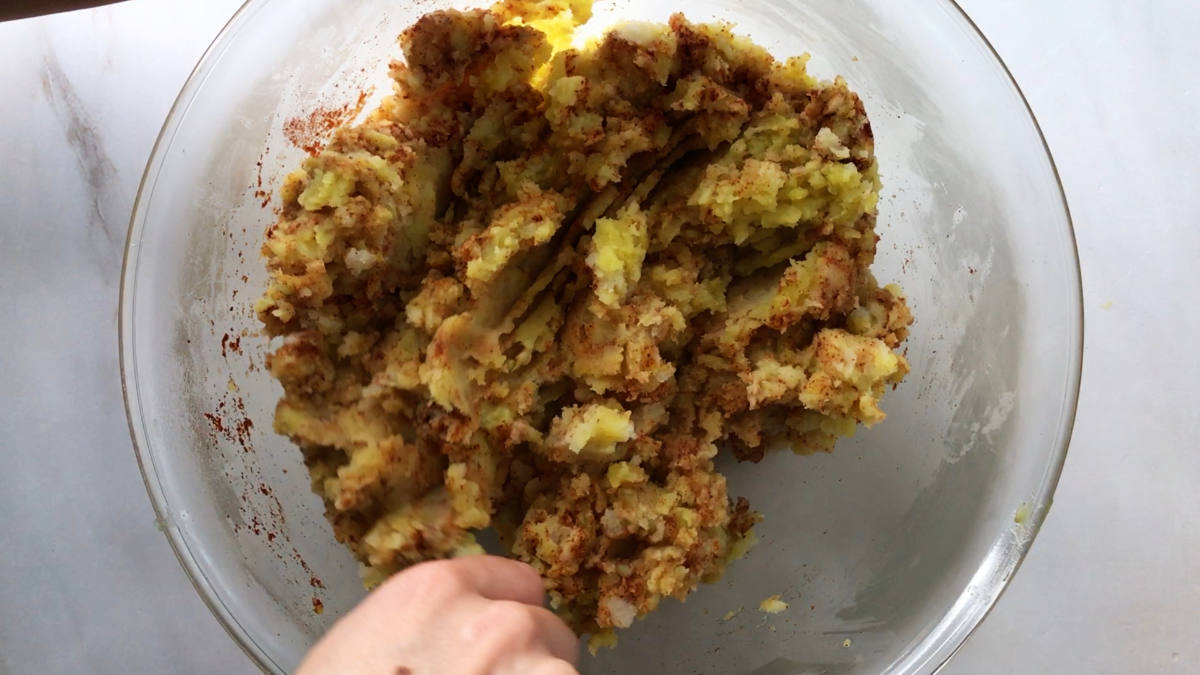 Spiced potato mixture in a bowl.