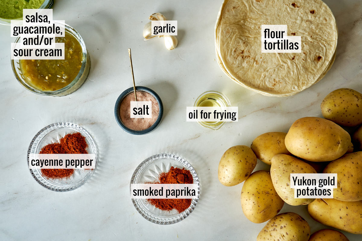 Potatoes and other ingredients on a countertop with labels.