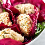 Fishcakes nested in radicchio.