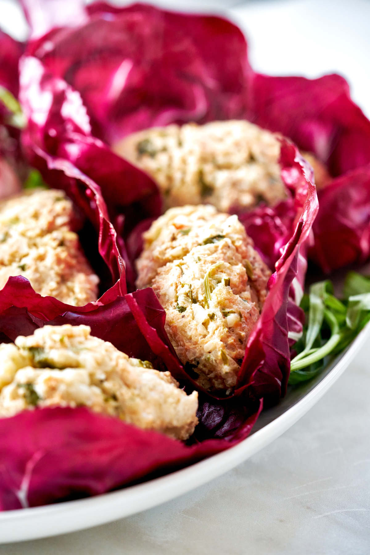 Fishcakes nested in radicchio.