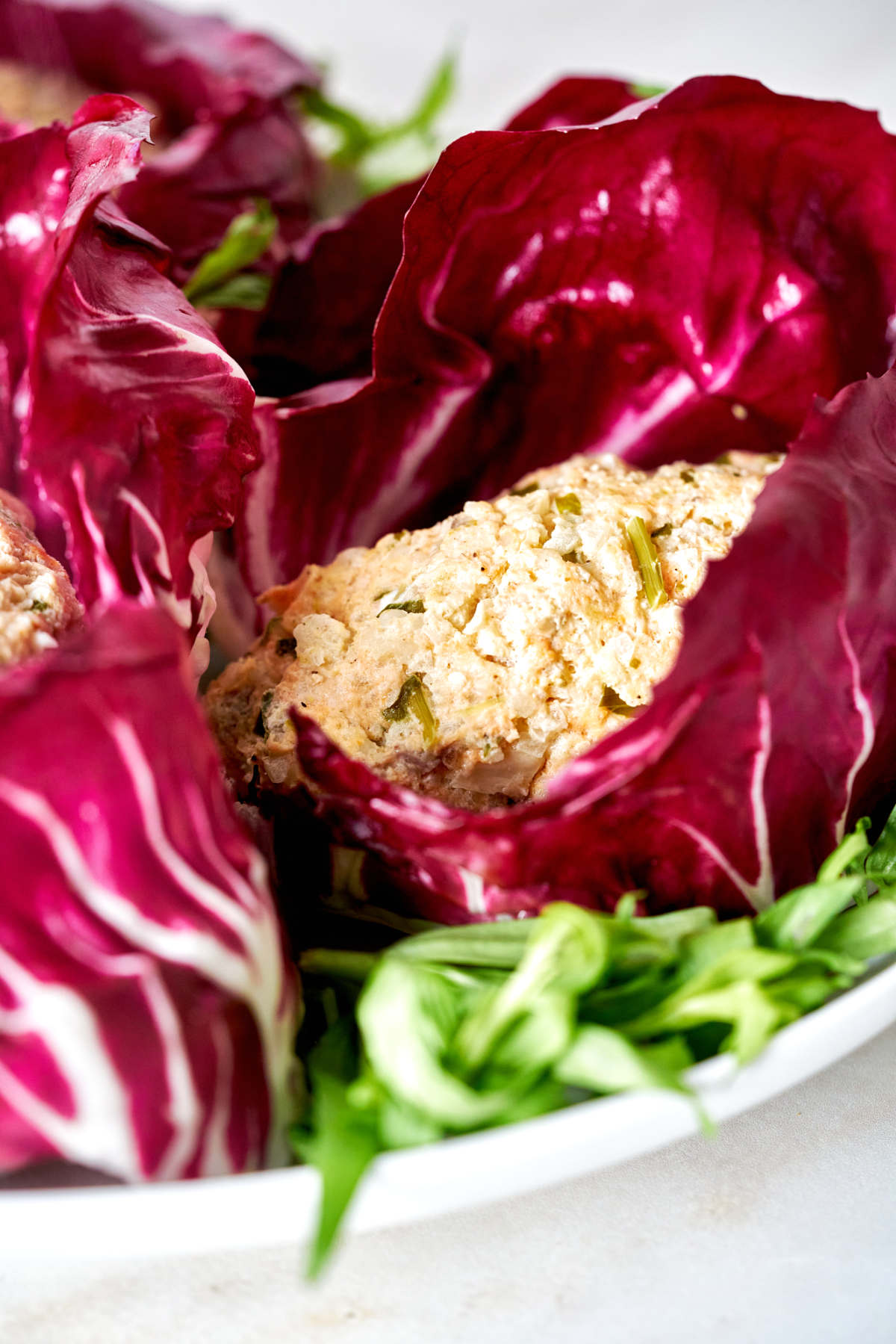 Fishcakes nested in radicchio.