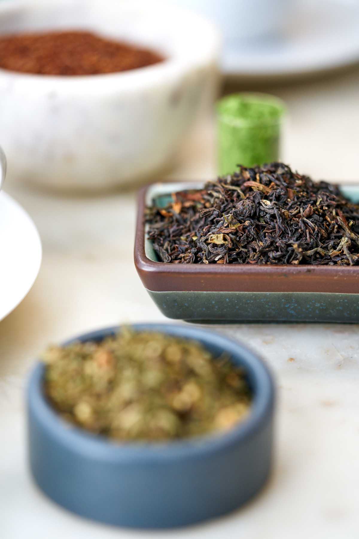 Loose leaf black tea in a ceramic dish.