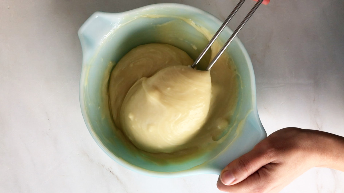 Melted cream fudge in a mixing bowl with a rubber spatula.