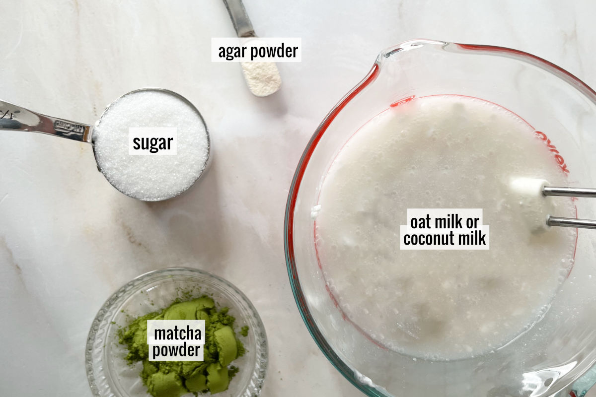 Ingredients to make a green tea panna cotta on a white countertop.