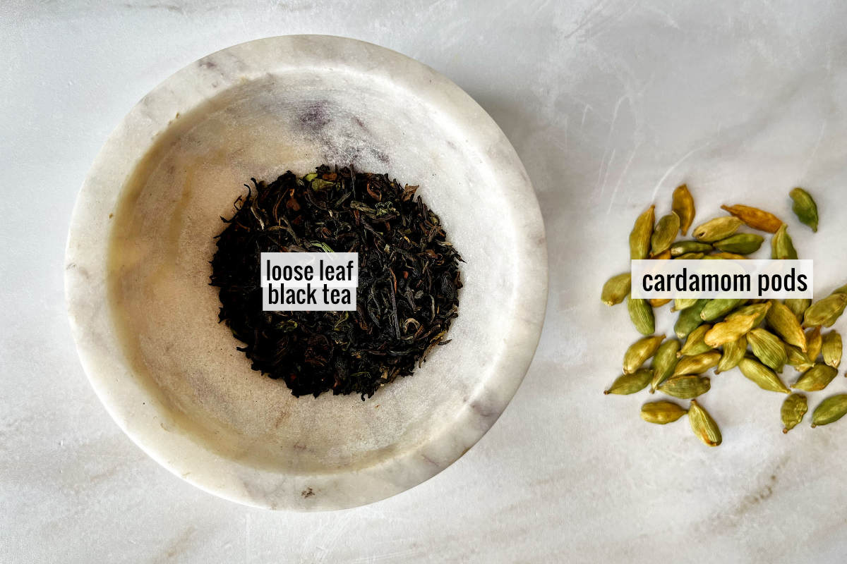 Tea and cardamom pods on a countertop.