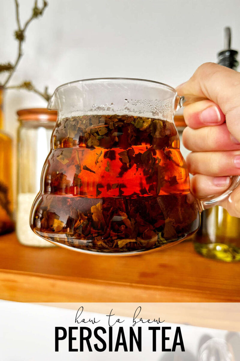 Brewed tea in a glass teapot above a wood floating shelf with title text.