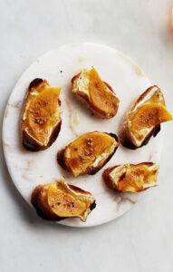 Crostini with orange fruit and cheese.