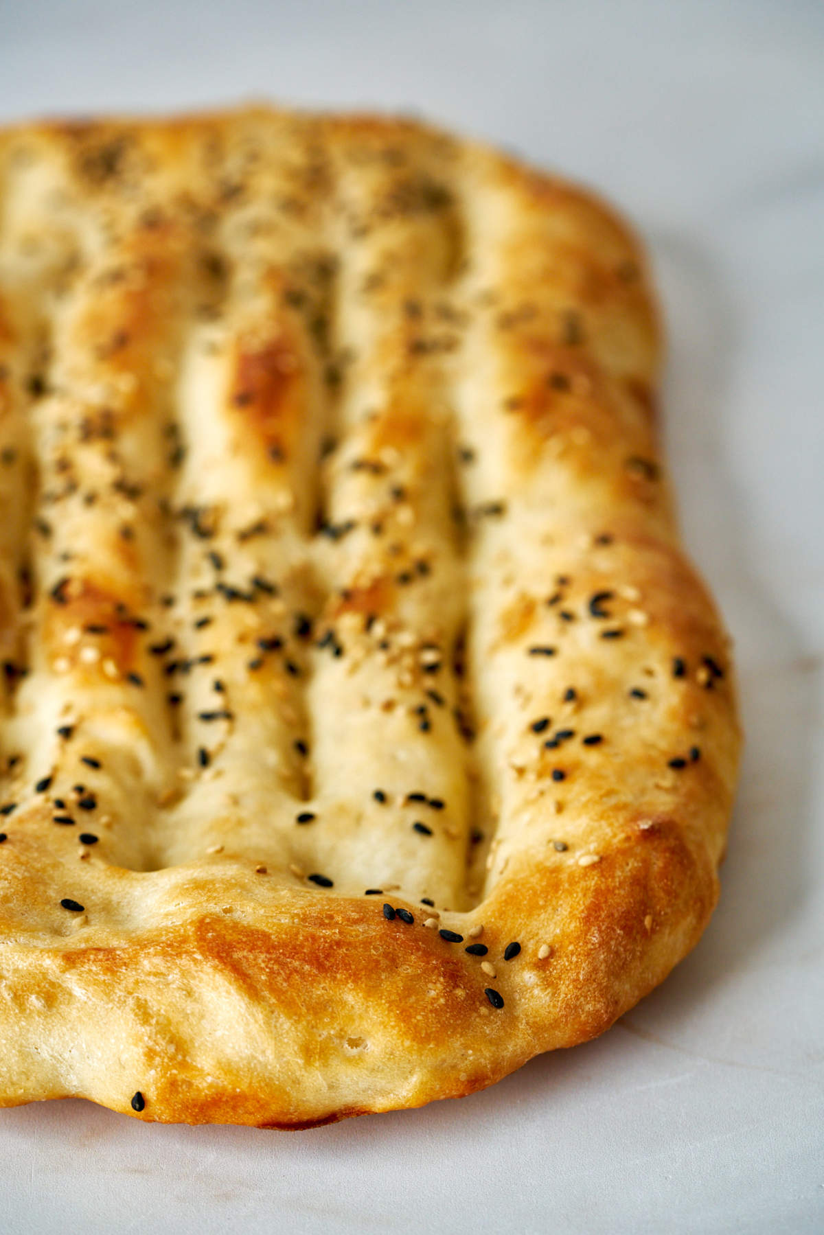 Flatbread with grooves on a white countertop.