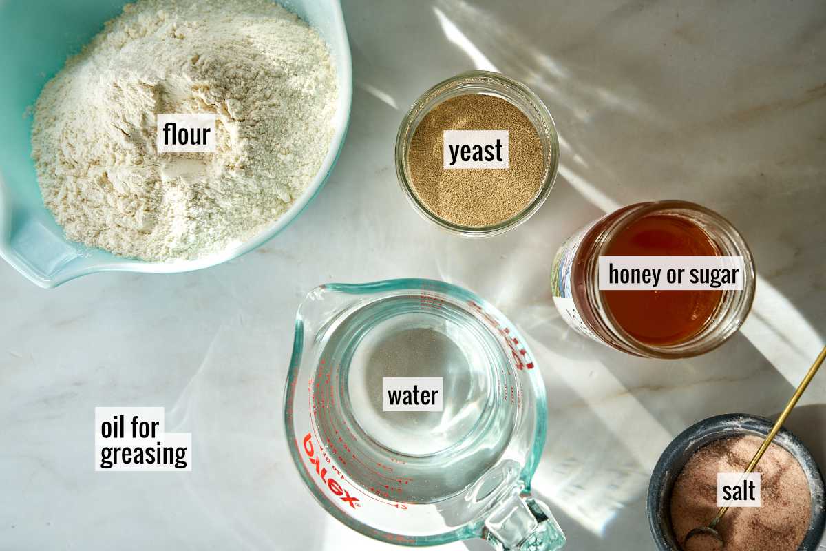 Flour and other ingredients on a white countertop.