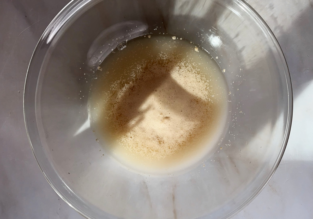 Foaming yeast in a glass bowl with sunlight.