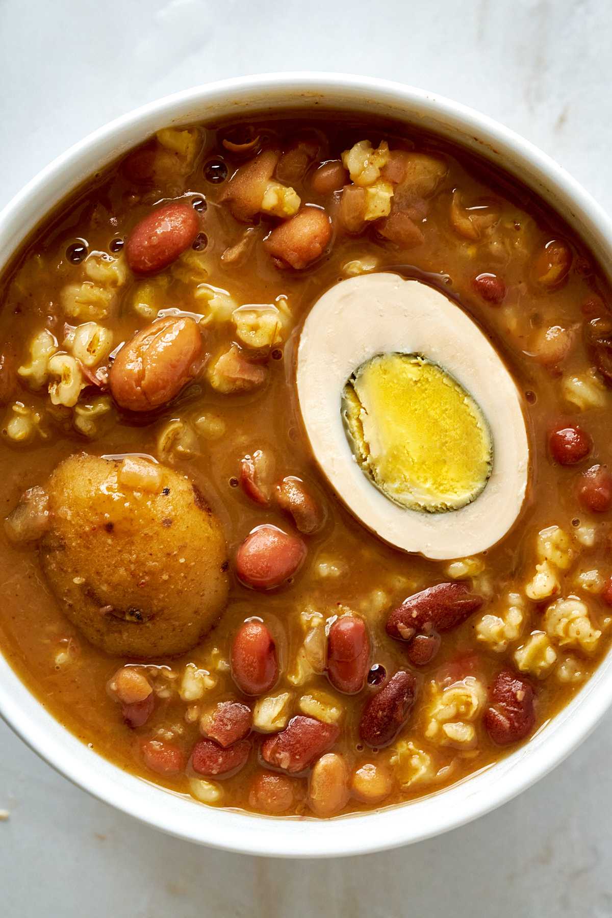 Bean soup with a hard boiled egg.