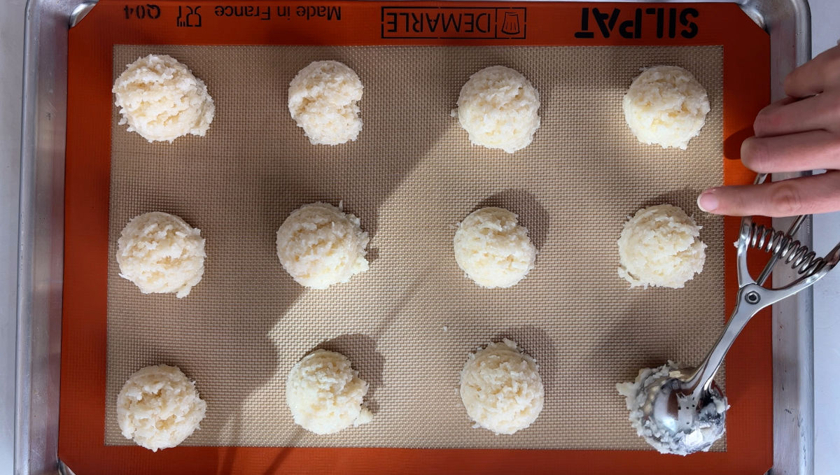 White cookies on a baking sheet.