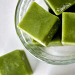 Green ice cubes in a bowl.