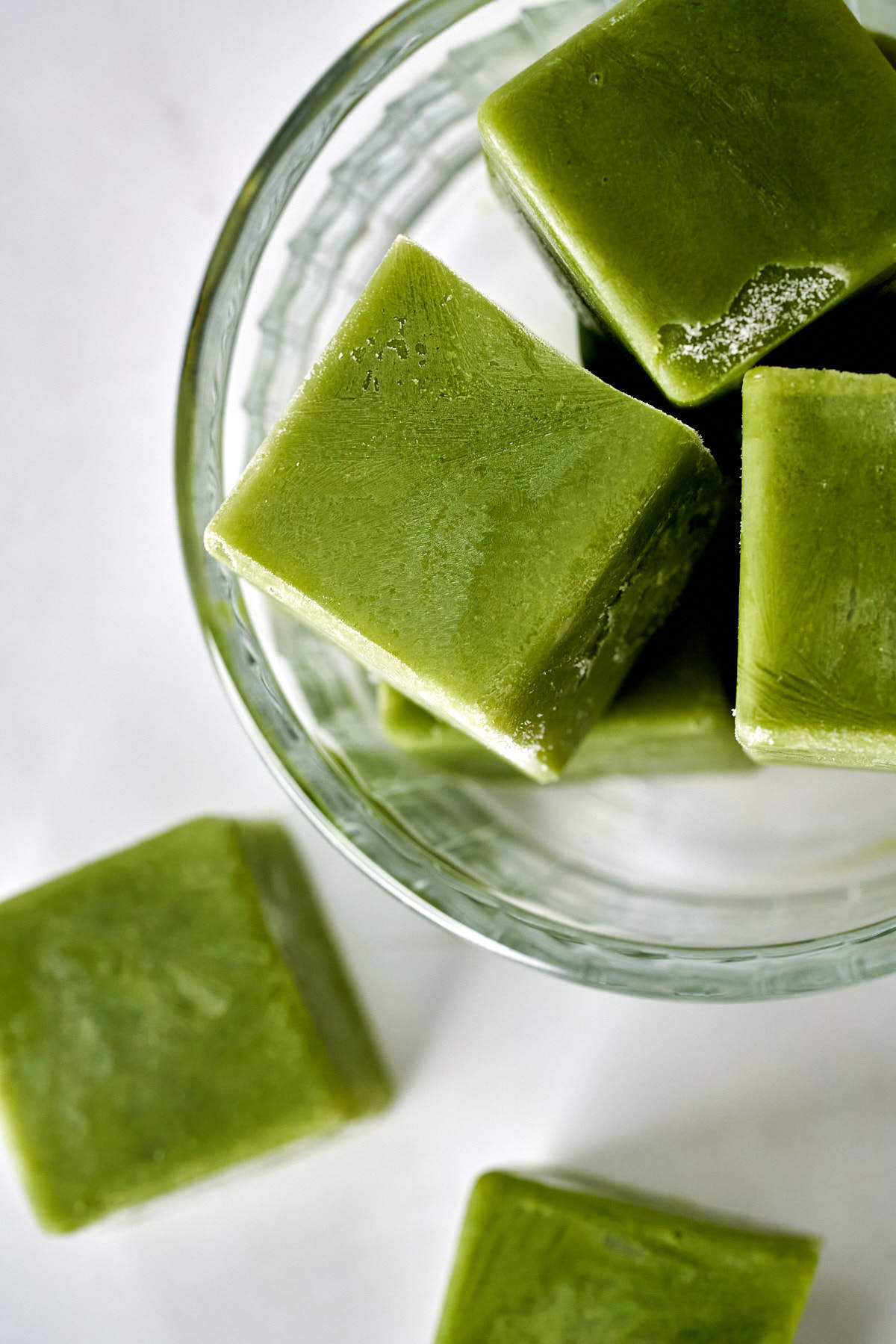 Green ice cubes in a bowl.