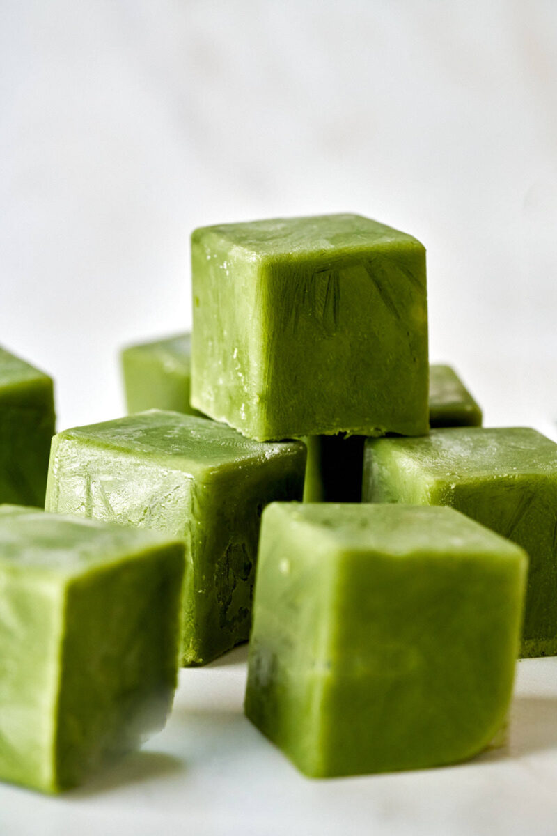 A stack and scattering of green ice cubes.