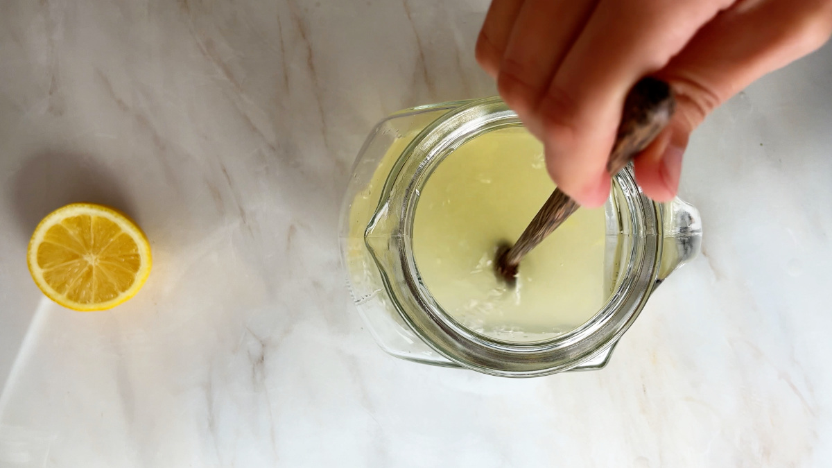 Stirring lemonade in a pitcher.