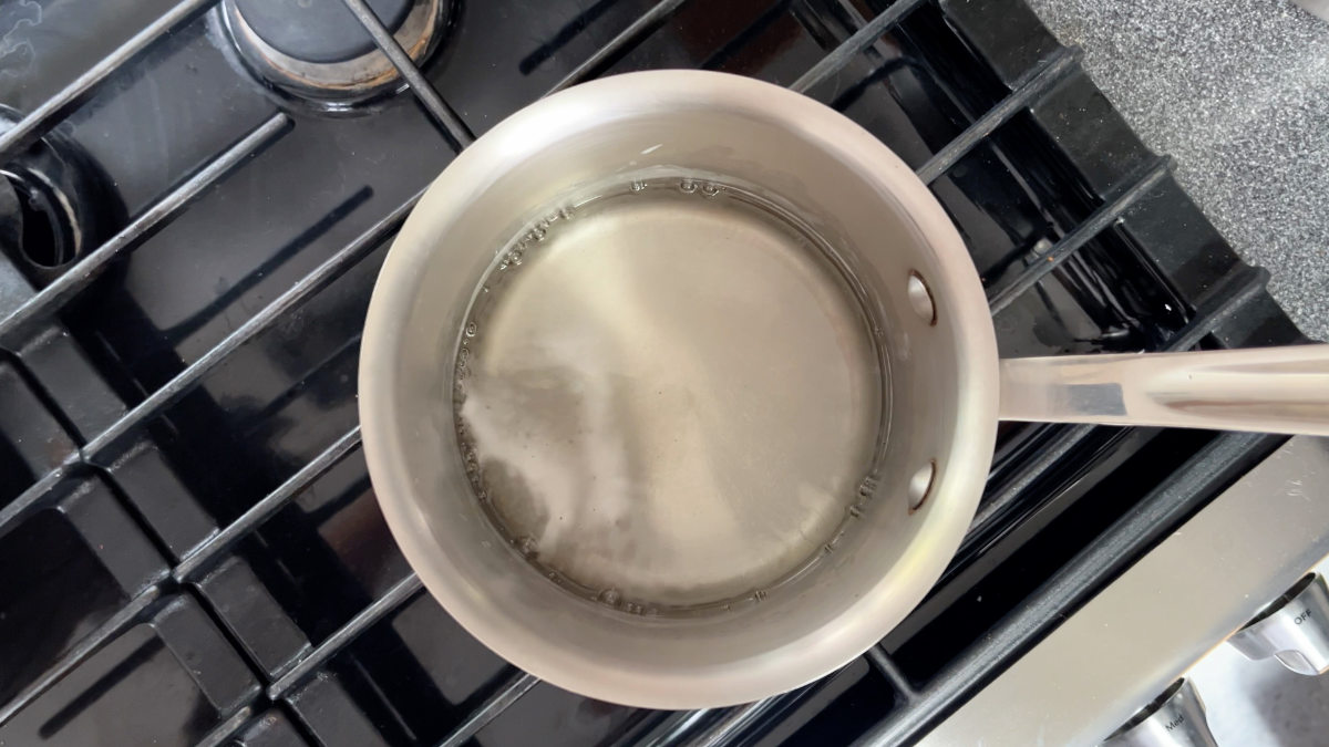 Water simmering in a pot on the stove.