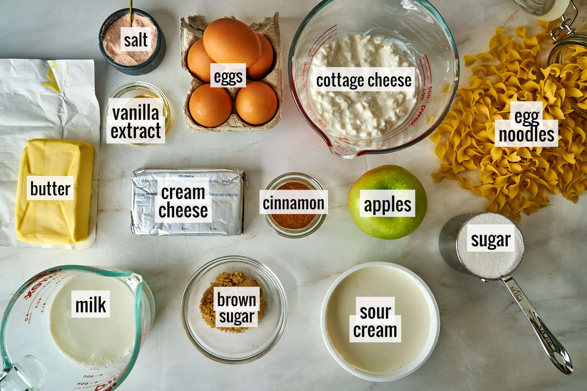 Noodles and other kugel ingredients on a white countertop.