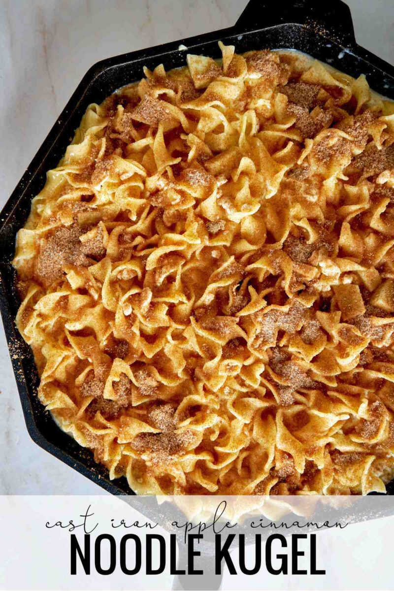 Baked noodle casserole with cinnamon topping in a cast iron pan.