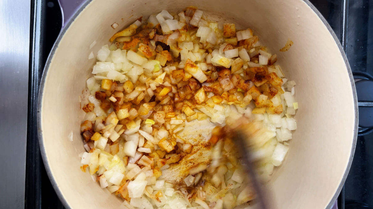Onions and spices cooking in a pot.