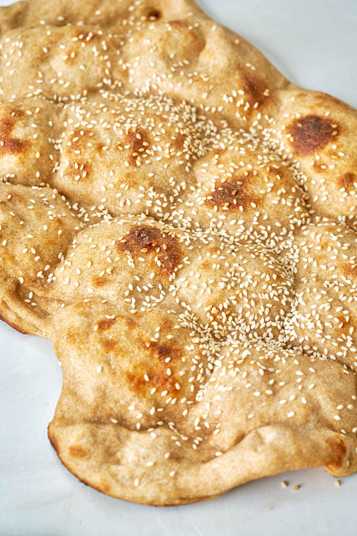 Wheat flatbread with sesame seeds.