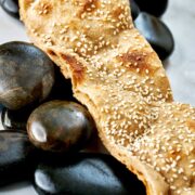 Strip of flatbread laying over rocks.