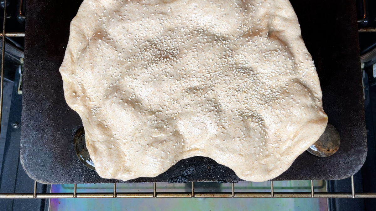 Bread dough on rocks in an oven.